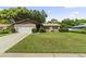 Charming single-story home featuring a well-maintained front lawn, brick accents, and attached garage at 7040 Betty St, Winter Park, FL 32792
