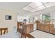 Bright kitchen with wooden cabinets, white appliances, and an eat-in area at 7040 Betty St, Winter Park, FL 32792