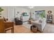 Inviting living room with hardwood floors, a piano, and large windows for natural light at 7040 Betty St, Winter Park, FL 32792