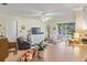 Cozy living room featuring a ceiling fan, large windows, and comfortable seating at 7040 Betty St, Winter Park, FL 32792
