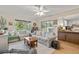 Spacious living room with hardwood floors, natural light, and a seamless flow to the kitchen at 7040 Betty St, Winter Park, FL 32792