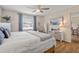 Well-lit bedroom with a large window, wood floors, and neutral decor creating a calm and inviting space at 7040 Betty St, Winter Park, FL 32792