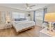 A serene bedroom featuring ample natural light, wood flooring, and comfortable decor at 7040 Betty St, Winter Park, FL 32792