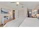 Spacious bedroom featuring wood floors and a ceiling fan, flowing into the en-suite bathroom at 7040 Betty St, Winter Park, FL 32792