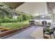 Spacious screened-in porch overlooking a lush backyard with comfortable seating at 7040 Betty St, Winter Park, FL 32792