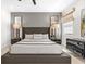This main bedroom has a gray accent wall, a gray bed frame, and natural light at 7416 Soiree Way, Reunion, FL 34747