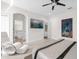 Comfortable and well lit bedroom with a luxurious lounge chair and adjacent bathroom access at 7416 Soiree Way, Reunion, FL 34747