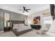 This main bedroom has a gray accent wall, a gray bed frame, and natural light at 7416 Soiree Way, Reunion, FL 34747