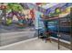 This bedroom features custom superhero wallpaper and a bunk bed with a desk at 7416 Soiree Way, Reunion, FL 34747
