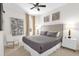 Cozy bedroom featuring decorative wall art, a ceiling fan, a window and neutral walls at 7416 Soiree Way, Reunion, FL 34747