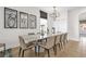 Elegant dining room with seating for eight, modern lighting, and contemporary artwork, perfect for entertaining at 7416 Soiree Way, Reunion, FL 34747