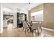 Cozy dining area with seating for four, a modern chandelier, and decorative shelving unit at 7416 Soiree Way, Reunion, FL 34747