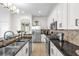 Well-equipped kitchen with granite countertops, stainless steel appliances, and white cabinets at 7416 Soiree Way, Reunion, FL 34747
