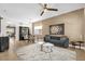 Inviting living room featuring plush seating, stylish rug, and decorative accents, adjacent to dining area at 7416 Soiree Way, Reunion, FL 34747