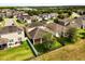 An aerial view showcases a spacious backyard with a fenced yard and screened in lanai at 1046 Grand Hilltop Dr, Apopka, FL 32703