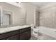 Bathroom features granite counters, dark wood vanity, large mirror, and shower-tub combo at 1046 Grand Hilltop Dr, Apopka, FL 32703