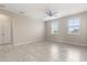 Neutral bedroom with gray tile flooring and natural light from the dual windows at 1046 Grand Hilltop Dr, Apopka, FL 32703