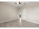 Neutral bedroom with tile flooring, ceiling fan, and an open doorway to another room at 1046 Grand Hilltop Dr, Apopka, FL 32703
