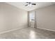 A neutral bedroom featuring tile floors, a ceiling fan, and a window with curtains at 1046 Grand Hilltop Dr, Apopka, FL 32703