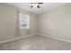 A neutral bedroom featuring tile floors, a ceiling fan, and a window with sheer curtains at 1046 Grand Hilltop Dr, Apopka, FL 32703