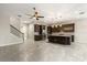 Open kitchen featuring dark wood cabinets, a stainless-steel refrigerator, an island, and tile backsplash, and is open to a stairwell at 1046 Grand Hilltop Dr, Apopka, FL 32703