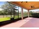 Covered lanai featuring a wood ceiling, ceiling fan, and views of the backyard and landscaping at 1046 Grand Hilltop Dr, Apopka, FL 32703