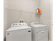 Laundry room with modern Whirlpool washer and dryer and convenient shelving at 1046 Grand Hilltop Dr, Apopka, FL 32703