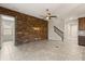 Bright living room with a stone accent wall, staircase, and tile floors leading to other parts of the house at 1046 Grand Hilltop Dr, Apopka, FL 32703