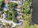 An aerial view showcases homes backing onto a serene lake, surrounded by lush greenery and mature trees at 1108 Summer Lakes Dr, Orlando, FL 32835