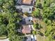 Aerial view of the houses shows the backyard with trees and wooden structures at 1108 Summer Lakes Dr, Orlando, FL 32835