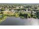 An aerial view captures homes nestled near a serene lake, surrounded by lush greenery and mature trees at 1108 Summer Lakes Dr, Orlando, FL 32835