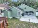 Rear view of home showcasing a large patio and low-maintenance yard at 1108 Summer Lakes Dr, Orlando, FL 32835