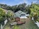 Green backyard featuring a wooden deck, patio, and mature landscaping at 1108 Summer Lakes Dr, Orlando, FL 32835