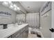 Stylish bathroom with granite countertop vanity and a shower-tub combination with decor at 1108 Summer Lakes Dr, Orlando, FL 32835