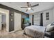 Bedroom with a dark accent wall, ceiling fan, a large window, and plank flooring at 1108 Summer Lakes Dr, Orlando, FL 32835