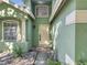 Inviting front entrance with a light-colored door, decorative window, and stone landscaping at 1108 Summer Lakes Dr, Orlando, FL 32835