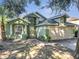 Charming two-story green home with an attached two-car garage and columned front window at 1108 Summer Lakes Dr, Orlando, FL 32835