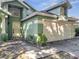 Inviting front exterior features a two-car garage, a front door, and mature trees at 1108 Summer Lakes Dr, Orlando, FL 32835