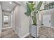 Hallway featuring wood-look flooring, a large plant, and modern lighting at 1108 Summer Lakes Dr, Orlando, FL 32835
