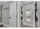 Hallway leading to a stylish bathroom with a gray vanity and a shower-tub combination at 1108 Summer Lakes Dr, Orlando, FL 32835
