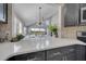 Quartz countertops in this sleek kitchen overlook a bright living space at 1108 Summer Lakes Dr, Orlando, FL 32835