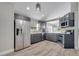 Modern kitchen with stainless steel appliances, gray cabinets, and plenty of natural light at 1108 Summer Lakes Dr, Orlando, FL 32835