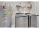 Laundry room featuring a newer washer, dryer, and a water heater with a shelf above at 1108 Summer Lakes Dr, Orlando, FL 32835