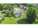 Aerial view of the home featuring the screened pool, landscaped yard, and mature trees in a quiet neighborhood at 1125 Almond Tree Cir, Orlando, FL 32835
