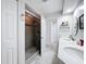 Updated bathroom featuring double sinks, modern tiles, and a glass-enclosed shower at 1125 Almond Tree Cir, Orlando, FL 32835