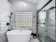 Elegant bathroom with a soaking tub, glass enclosed shower and modern fixtures for a relaxing experience at 1125 Almond Tree Cir, Orlando, FL 32835