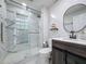 This bathroom features modern fixtures and sleek marble-style tiles in the shower and throughout the room at 1125 Almond Tree Cir, Orlando, FL 32835