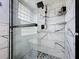Glass enclosed shower featuring a rainfall shower head and marble-look tile for spa-like experience at 1125 Almond Tree Cir, Orlando, FL 32835