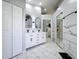 Open bathroom featuring double vanities, marble floors, glass shower and views to the bedroom at 1125 Almond Tree Cir, Orlando, FL 32835