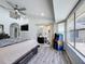 Bright bedroom with modern ceiling fan, vinyl flooring, arcade game and glass slider to the outdoor patio at 1125 Almond Tree Cir, Orlando, FL 32835